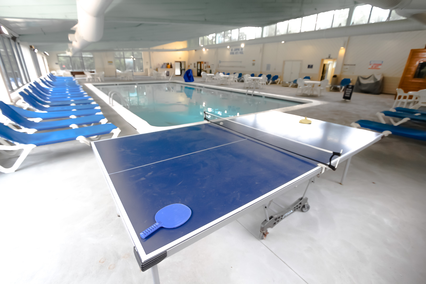 An indoor swimming pool with ping pong table VRI's Sea Mist Resort in Massachusetts.